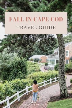 a woman walking down a brick path with the words fall in cape cod travel guide