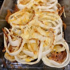 onions are being cooked in an oven with cheese on the top and other toppings