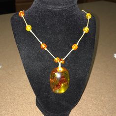 Baltic Amber Stones Large Hanging Pendant With A Large Historic Encased Insect. Rope Stranded Balls. Tie Closure. A Crack On The Front Of Large Pendant. A Scratch & Small Pore Holes On The Back. A Lovely Statement. Smaller Pores, Long Necklaces, Amber Necklace, Amber Stone, Hanging Pendant, Amber Jewelry, Hanging Pendants, Baltic Amber, Long Necklace