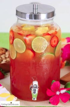 a pitcher filled with fruit and lemons on top of a table