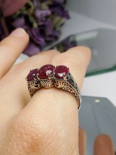 Natural Gemstone Three Stone Cocktail RingSmall 3Stone Design#D41 This is a high-quality filigree ring in sterling silver. This cocktail ring is set with 3 natural gemstones of excellent quality. Inspired by Art Deco era designs, this exquisite filigree ring is an antique reproduction. The full cut gemstone in the center is 8mm x 6mm, the two side gems are 7mm x 5mm. The 3 stones together, east-west on the finger, are 17mm across. The band is marked 925 for sterling silver. Notice the fine Art D Elegant Silver Three-stone Gemstones, Elegant Three Stone Silver Gemstones, Silver Ruby Ring With Three Stones In Oval Shape, Silver Three-stone Ruby Ring, Elegant Silver Ruby Three Stone Ring, Silver Ruby Ring With Three Stones, Elegant Silver Ruby Ring With Three Stones, Formal Silver Ruby Ring With Three Stones, Formal Silver Ruby Three Stone Ring