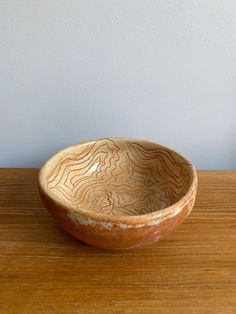 a wooden bowl sitting on top of a table