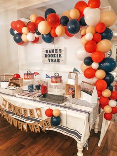 a table with balloons and decorations on it