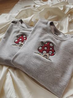 "Mushroom House Embroidered Sweatshirt! Embroidered on a cotton/polyester blend crewneck sweatshirt! This design is simple and minimalistic perfect for the cottage core look! -Embroidery design measures 5\" x 4\" -See product pictures for shirt sizing chart. -All sweatshirts are handmade on an embroidery machine so there may be slight differences, but we only sell the sweatshirts that meet our high-quality standards. -To maintain the quality of your sweatshirt and the embroidery design make sure Cotton Fall Sweatshirt With Mushroom Print, Cotton Sweatshirt With Mushroom Print, Cotton Sweatshirt With Mushroom Print For Fall, Cotton Crew Neck Sweatshirt With Mushroom Print, Casual Crew Neck Sweatshirt With Mushroom Print, Cotton Long Sleeve Sweatshirt With Mushroom Print, Sweatshirt Embroidery Ideas, Toadstool Mushroom, Halloween Tee Shirts