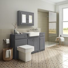 a bathroom with two sinks, a toilet and a bathtub in it's corner