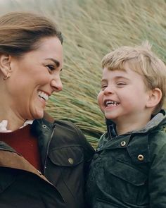 the young boy is smiling with his mother