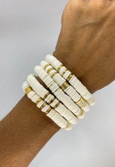 "This listing is for 1 White and gold Bracelet. Each bracelet is hand-beaded with African clay discs and accented with brushed gold cylinder discs. The bracelet is made with stretch elastic which makes it comfortable and easy to wear. My bracelets are made to fit an average wrist size of 6.5\"-7\". Take a look around my shop for additional colors to add to your stack! The more the better!" Hand-strung Gold Heishi Beads Stretch Bracelet, Gold Stacked Heishi Beads Stretch Bracelet, White And Gold Bracelet, Rainbow Bracelet, Summer Bracelets, Black Bracelets, Cross Bracelet, Heishi Beads, Name Bracelet