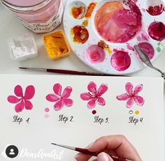 someone is painting flowers with watercolors on the paper and then using it to paint them