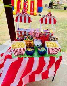 a table topped with lots of candy and popcorn