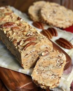 pecan bars on a cutting board with pecans in the background