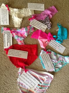 several different types of bras are on the floor with tags attached to each one