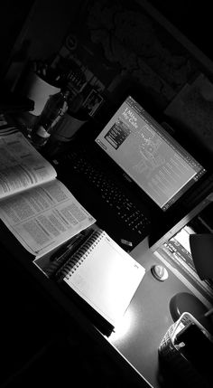 an open laptop computer sitting on top of a desk next to a keyboard and mouse