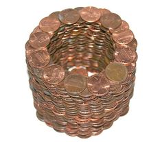 a stack of copper coins sitting next to each other on top of a white surface