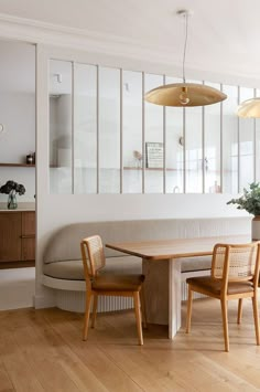 a dining room table with two chairs and a bench