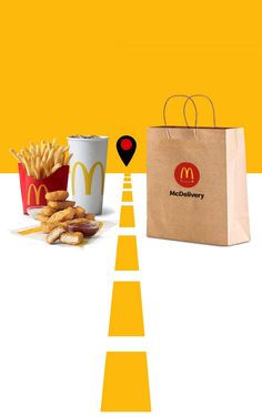 a mcdonald's bag next to some french fries on a table with a map marker