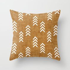 a brown pillow with white arrows on it