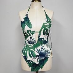 The Bikini Lab Womens Swimsuit Plunge Halter One Piece Floral Tropical New With Tags Medium White V-neck Tropical Swimwear, Tropical Green Bodysuit For The Beach, Tropical Green Bodysuit For Vacation, Green Halter Neck Bodysuit For Beach, White Halter Neck Swimwear With Tropical Print, White One-piece Swimwear With Tropical Print, Green Halter Neck Bodysuit For Poolside, Green Backless Beachwear Bodysuit, Tropical White One-piece Swimwear