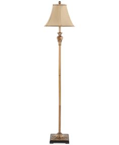 a floor lamp with a beige shade on it