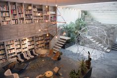 a room filled with lots of books and furniture