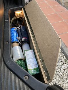 an open trunk filled with assorted items on the ground