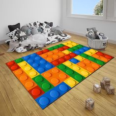 a room with toys on the floor and a rug that looks like a lego block