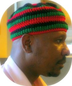 a man wearing a red, green and black striped hat