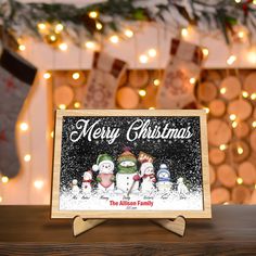 a merry christmas card with three snowmen on it sitting in front of a fireplace