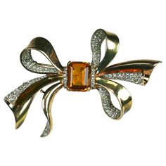 Trifari Retro 2 tone bow knot brooch of 14 karat yellow/rose gold plate sterling silver with focal rectangular cut faux topaz and crystal rhinestone pave. Excellent Condition ,Signed Length 3.50, Width 1.75 Goth Wardrobe, Rose Gold Plate, Retro 2, Trifari Jewelry, Crown Trifari, Vintage Jewelry Box, Bow Jewelry, Bow Knot, Vintage Jewels