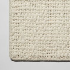 a white rug with small squares on it