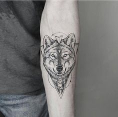 a man with a wolf tattoo on his arm