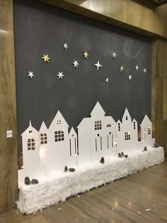 a display with white houses and stars on the wall