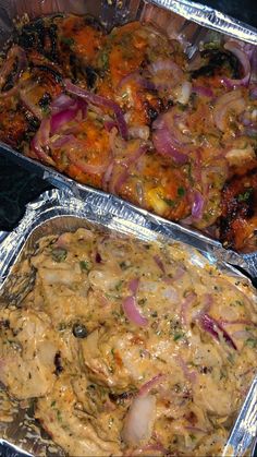 two tin foil pans filled with food sitting on top of a stove next to each other