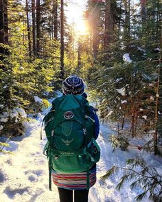 a person with a backpack walking in the snow