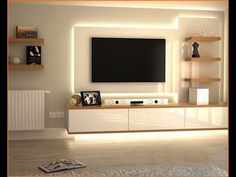 a living room with white furniture and a flat screen tv mounted on the wall above it