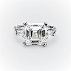 an emerald cut diamond ring with three baguets