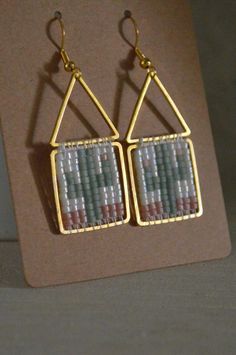 the earrings are made out of glass beads and gold plated metal wire, with small squares on each side