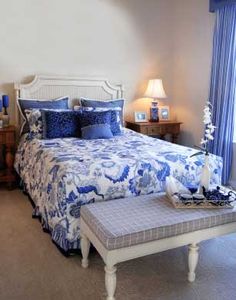 a blue and white bed in a bedroom