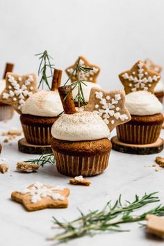 cupcakes with frosting and sprigs on top