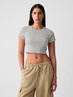 Soft cotton-blend ribbed knit ultra-cropped T-shirt.  Crewneck.  Short sleeves.  Certain styles have allover prints.  * Fit: Stretch-to-Fit.  Slim & stretchy that forms to your shape.  Ultra-cropped, hits at the waist.  Models wearing Gap