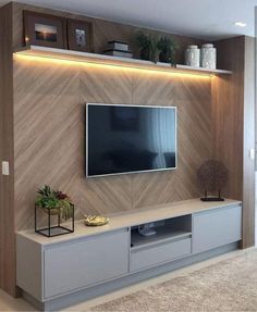 a tv is mounted on the wall in a living room