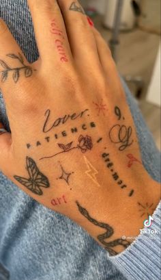 a person's hand with tattoos on it and the words love written in different languages