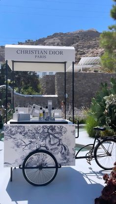 an ice cream cart sitting in front of a mountain