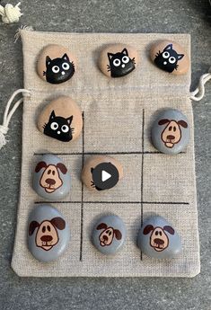 rocks with cartoon dogs and cats painted on them