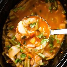 a spoon full of soup in a crock pot