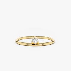 a yellow gold ring with a single diamond