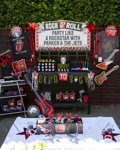 a rock and roll themed party with guitars, signs, and other items on display