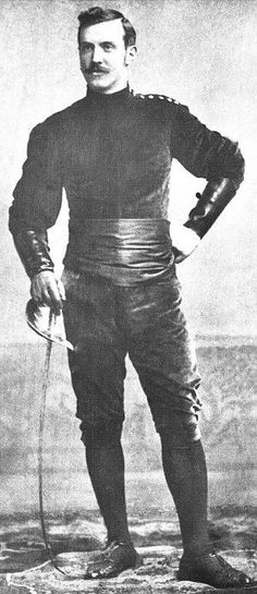 an old black and white photo of a man in leather clothes with his hands on his hips