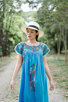 "Beautiful Mexican dress in shade of light blue with floral embroidery. Mexican traditional dress. Bright colorful floral embroidery. With White crochet lace on neck and sleeves. Tailored chest with little people on smocking. Conditions : in good vintage condition **difference color under armpits (shown in the last picture) BEST FIT = M Please be sure to check the measurements to insure a perfect fit. Details and Measurements (Inch) BUST: 46 \"measure from armpit to armpit SHOULDER TO SHOULDER: Embroidered Light Blue Cotton Dress, Blue Floral Embroidery Short Sleeve Dress, Blue Embroidered Dress For Festival, Light Blue Embroidered Cotton Dress, Blue Folk Style Dress With Intricate Embroidery, Blue Folk Dress With Intricate Embroidery, Blue Folk Embroidered Dress With Intricate Embroidery, Traditional Light Blue Summer Dress, Blue Cotton Folk Dress