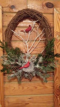 a wreath with two red birds on it