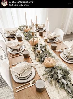 the table is set with candles, plates and place settings for dinner guests to enjoy